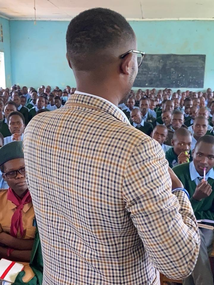 Dr. Kevin Muchiri speaking to students in a classroom